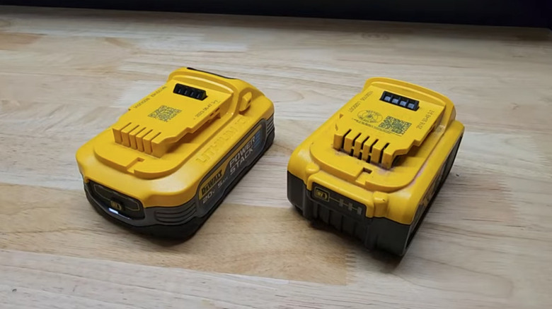 Two DeWalt batteries with pins showing