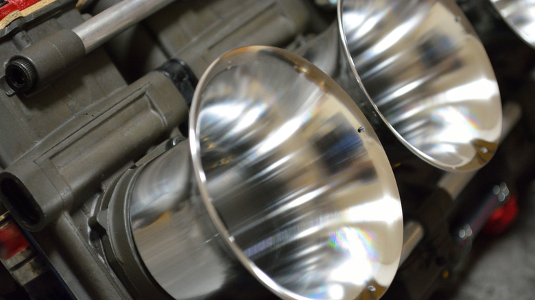 A close-up of two shiny velocity stacks