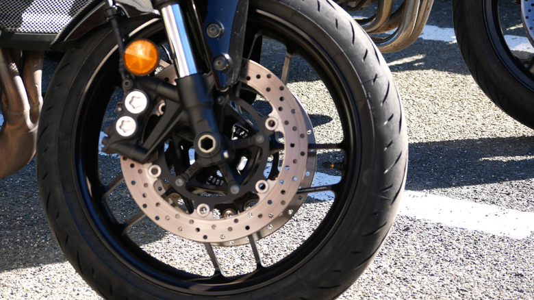 A close-up of the front wheel of an unidentified motorcycle
