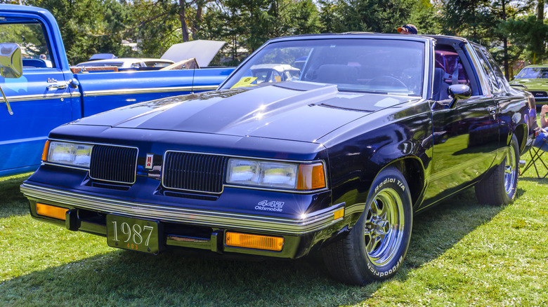 Blue 1987 Oldsmobile 442 parked on grass