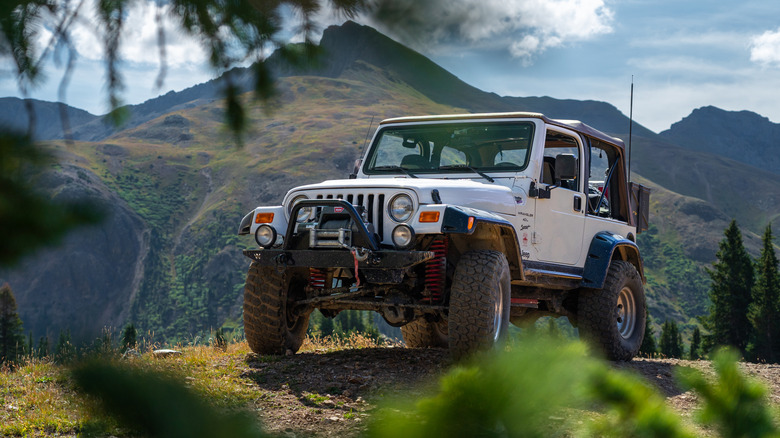off-road SUV going up steep mountain
