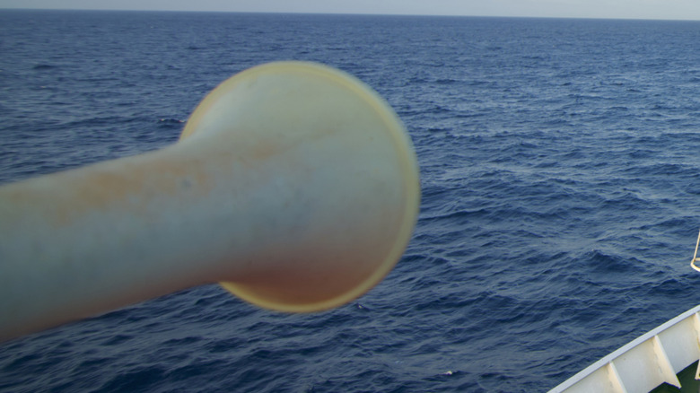 A close-up of a boat horn with the blue sea in the background