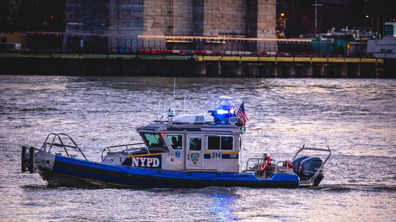 NYPD boat with flashing blue light.