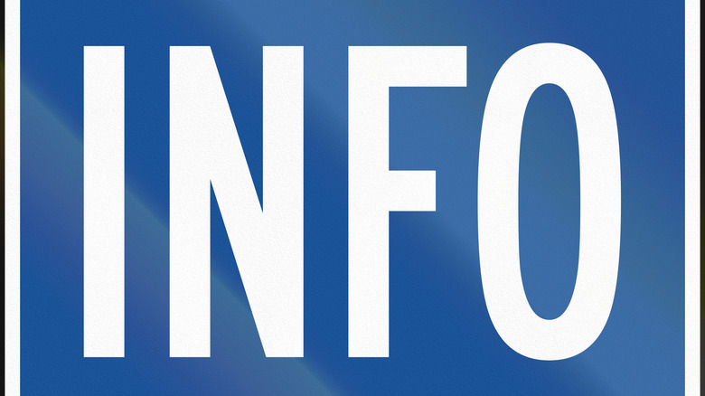Close-up of blue tourist center traffic sign with the word INFO printed on it.
