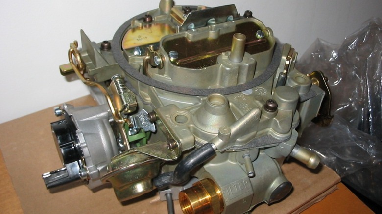 A 1982 Rochester Quadrajet carburetor with electric choke.