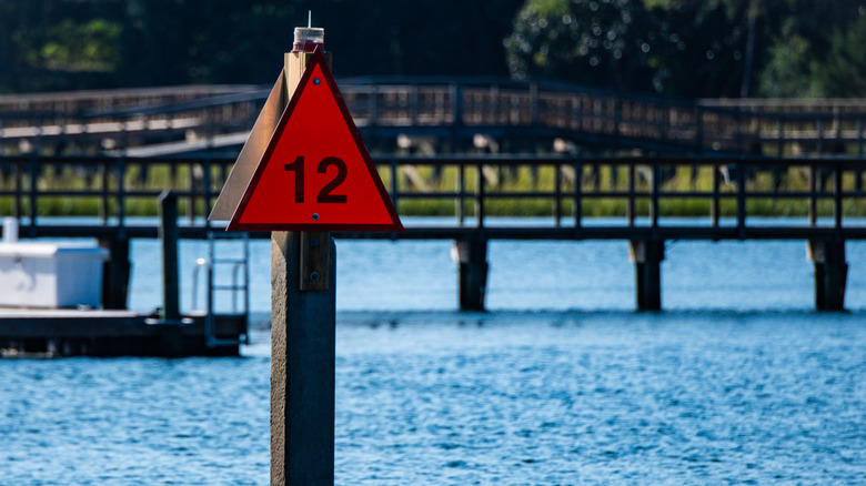 Fixed red triangle channel marker in the water