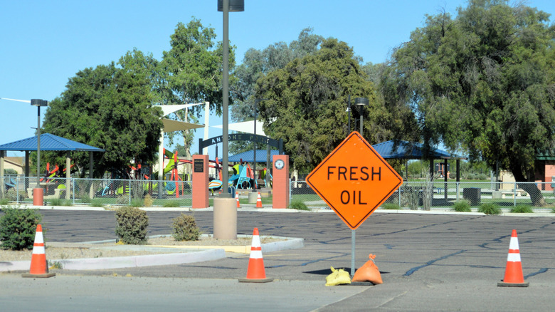 Road sign indicating fresh oil.
