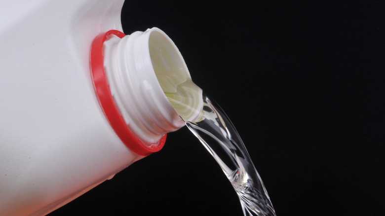 Close up of bleach being poured from bottle