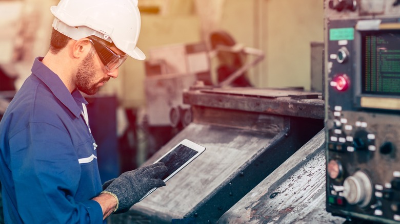 A worker operating CNC equipment.