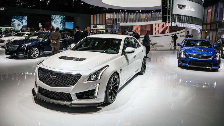 A white Cadillac CTS-V on display among other Cadillacs.