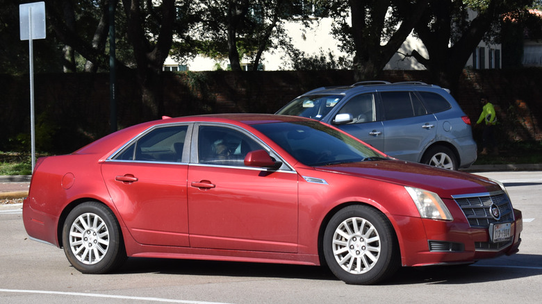 A red Cadillac CTS on a street.
