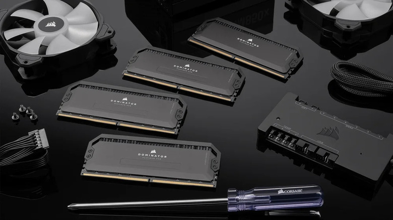 Several Corsair RAM kits next to a screwdriver, fans, and screws