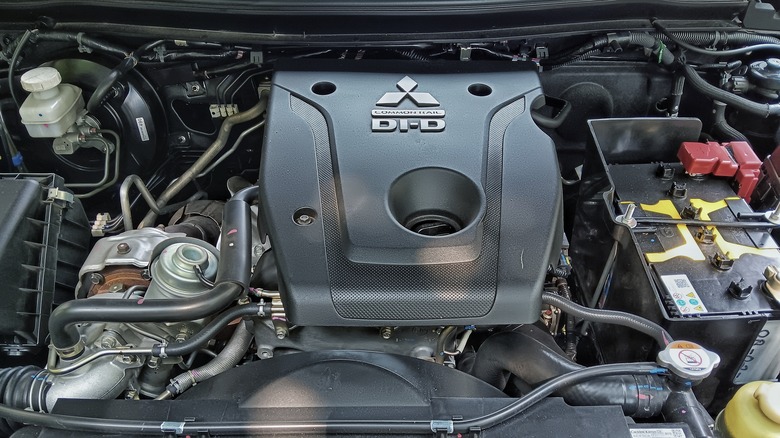 Underhood view of a Mitsubishi CRDI diesel engine, branded as Commonrail DI-D