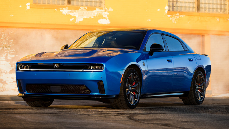 Blue 2025 Dodge Charger Daytona Scat Pack EV parked in front of a building