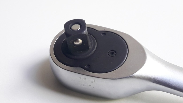 an up close image of a ratchet wrench's drive post, featuring a detent pin