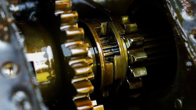 Inside of a gearbox with the components coated in oil.