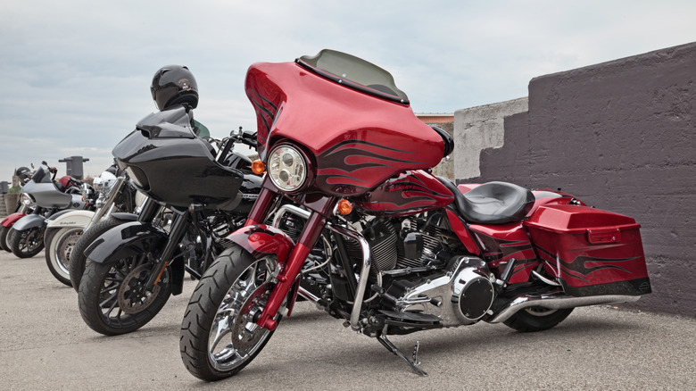 Harley-Davidson tourers parked at a motorcycle meetup on a gloomy day