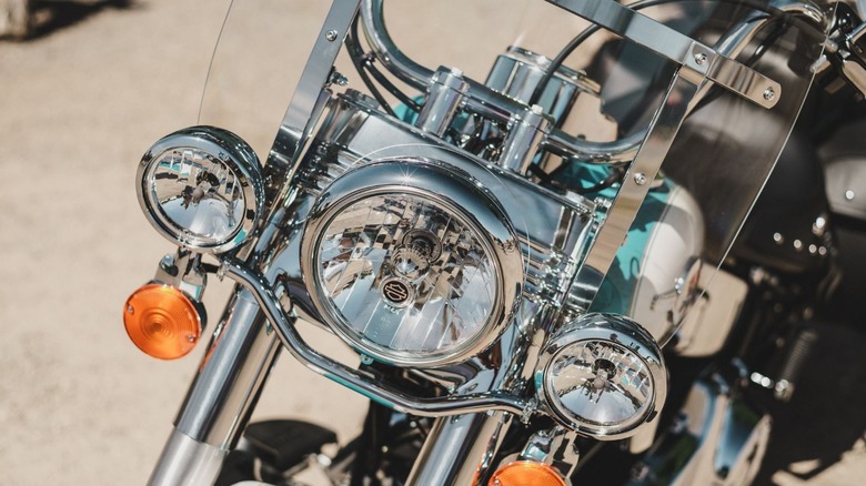 A close up of a chrome Heritage Softail Classic with a focus on its headlights