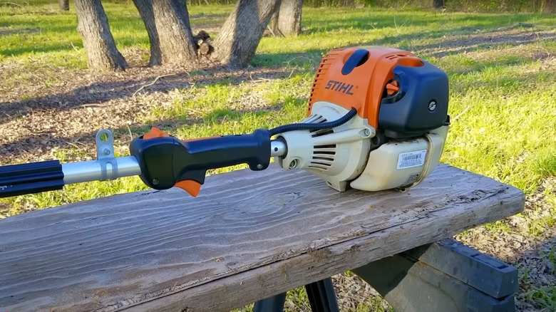 A Stihl trimmer on a wooden table