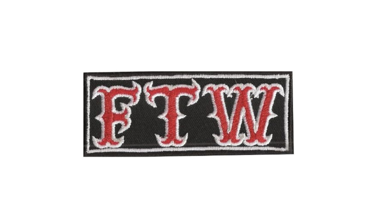 Black patch with red and white "FTW" embroidery