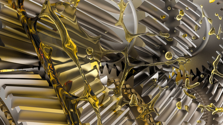 A close-up of oil splashing over a gearbox