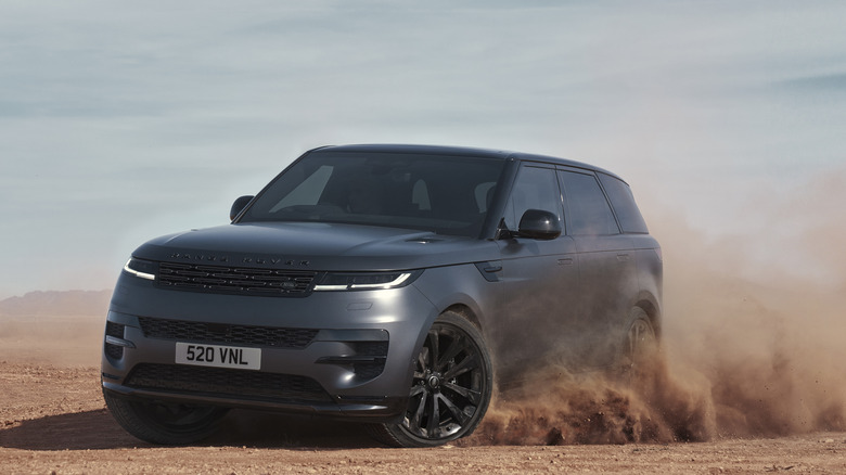 2025 Land Rover Range Rover Sport Stealth Pack, front 3/4 view, drifting through sand