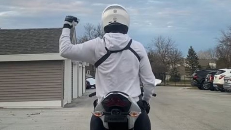 Motorcycle Rider using hand signal indicating right turn