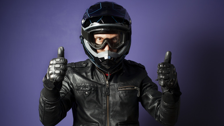 Motorcycle rider giving thumbs up sign