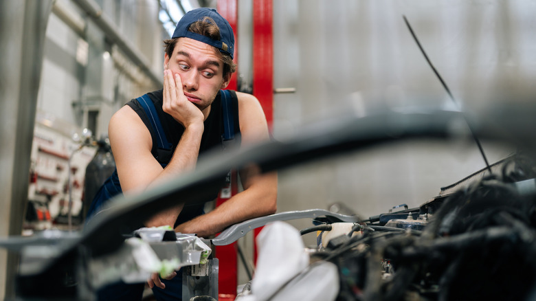 Mechanic inspecting engine