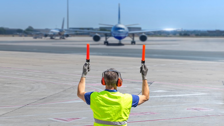 Aircraft marshall directing plane on a runway