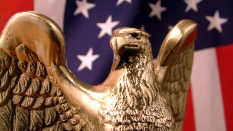 Gold eagle statue in front of an American flag