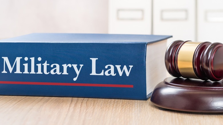 Book of military law beside a gavel