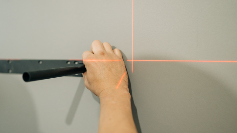 Using laser level to level hanging shelf