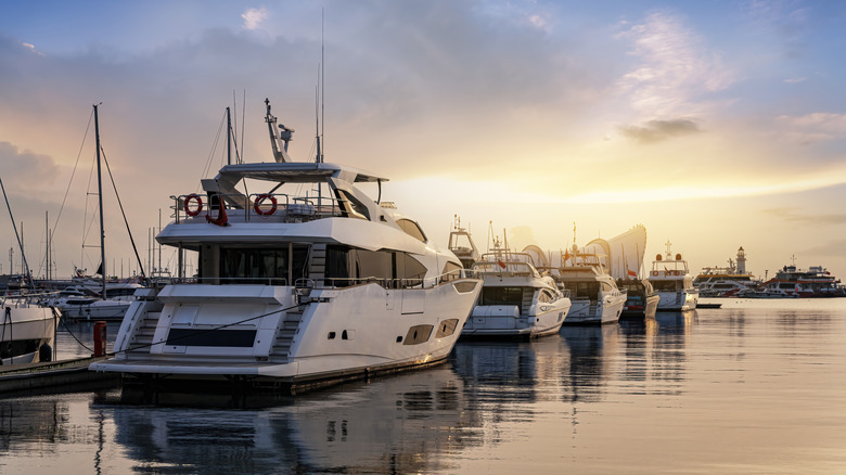Boats docked at marina at sunset