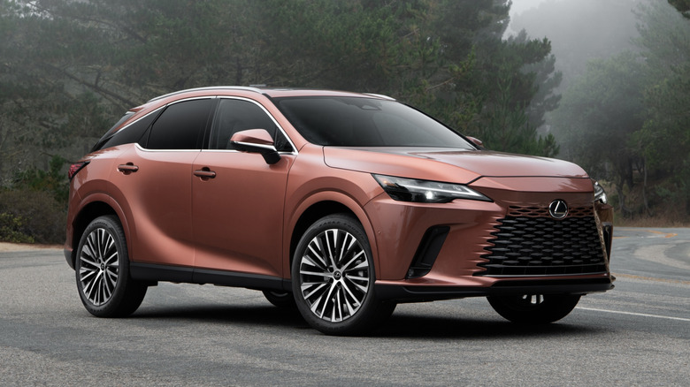 Copper 2025 Lexus RX 350 parked on a paved surface with trees in the background, front 3/4 view