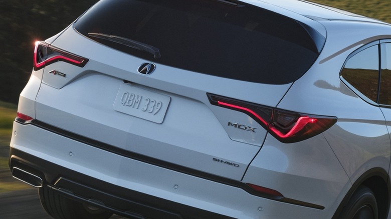 Rear view of a white Acura MDX showing the MDX badge