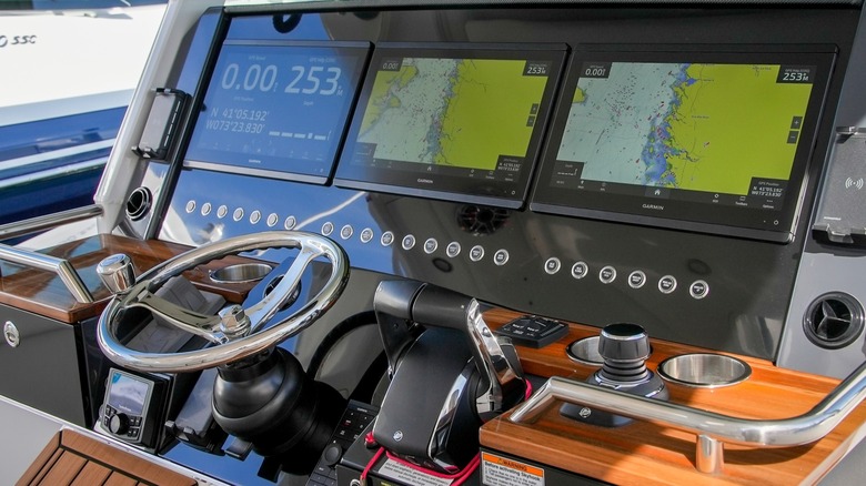 A multifunction display in a boat with several sections displaying data.