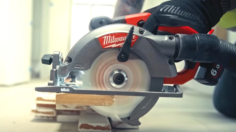 Person using Milwaukee Tools circular saw