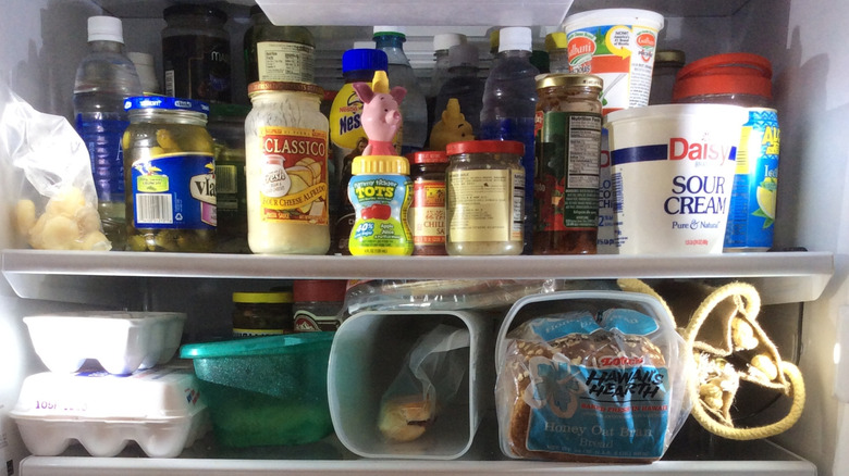 Close-up of a refrigerator's shelves full of food.
