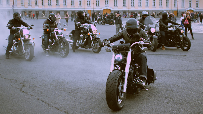 A group of bikers gathered at a location with their respective bikes