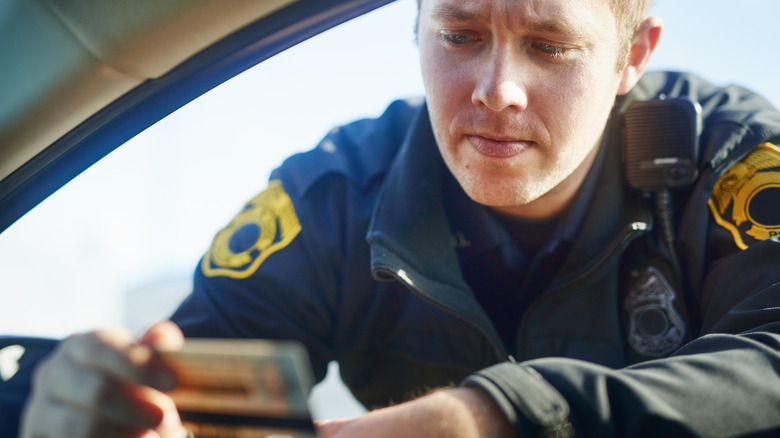 Traffic officer checking driving license