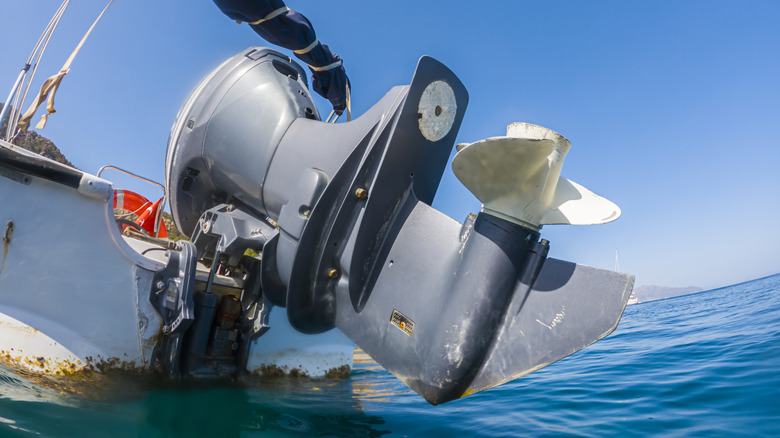 Close-up of outboard engine on boat, lifted out of water