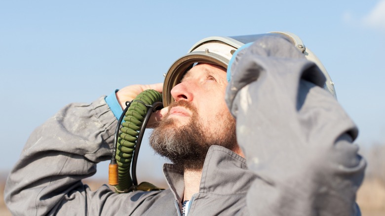 Man in gear looks up
