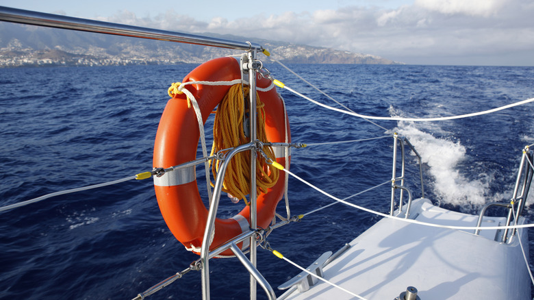 Ring buoy attached to boat on the water.