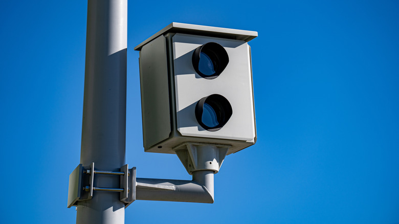 Close up of traffic enforcement camera against blue sky