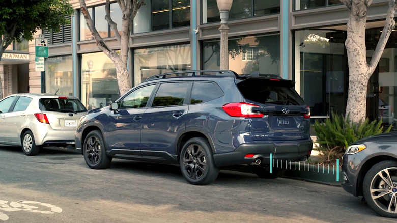 Person backing up in parking space in a Subaru