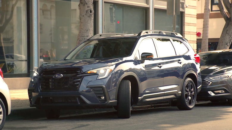 Person pulling out of parking space in Subaru