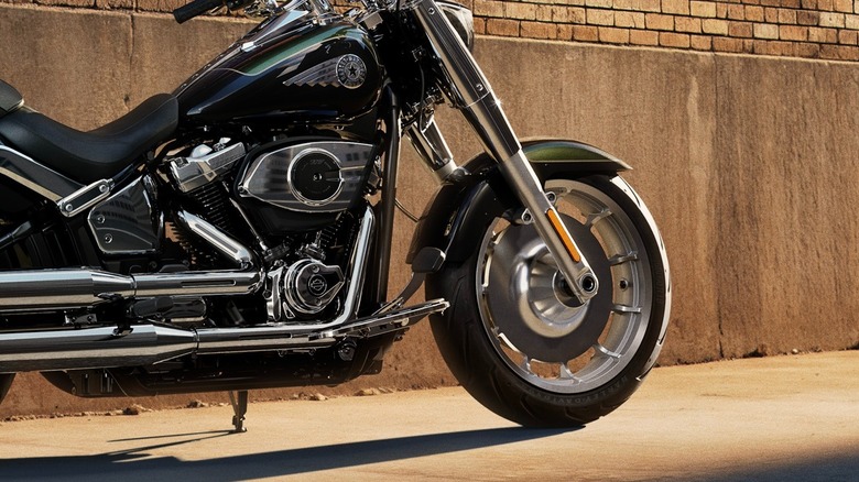 Side view of a 2026 Harley-Davidson Fat Boy parked against a brick wall