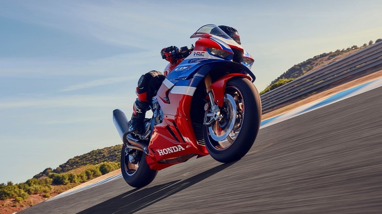 Rider leaning a Honda CBR1000RR-R Fireblade SP into a corner on a racetrack