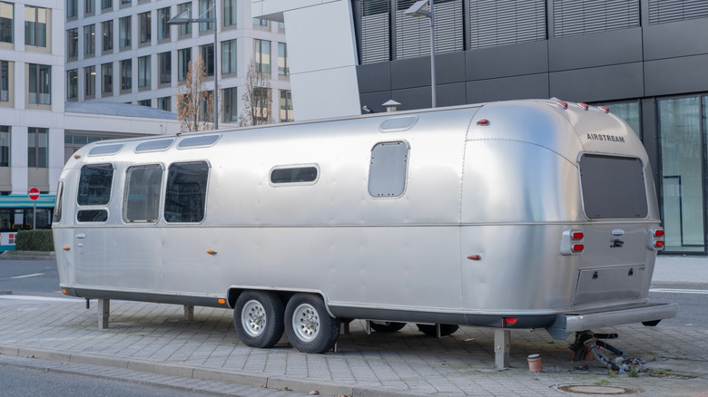 Airstream travel trailer parked on city street